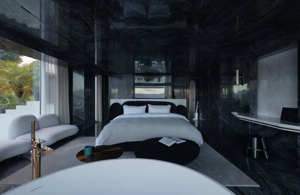 Modern bedroom featuring minimalist design with metal and glass elements