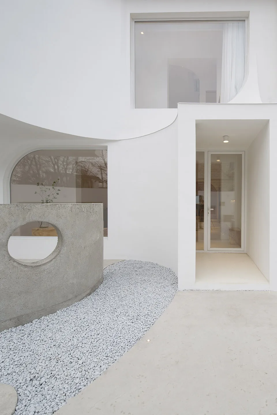 A modern exterior featuring concrete materials and minimalist design elements.