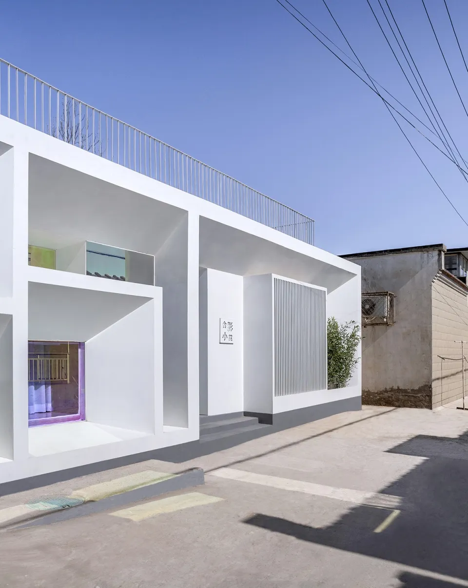 Modern white house with concrete and glass exterior features clean, minimalist design.