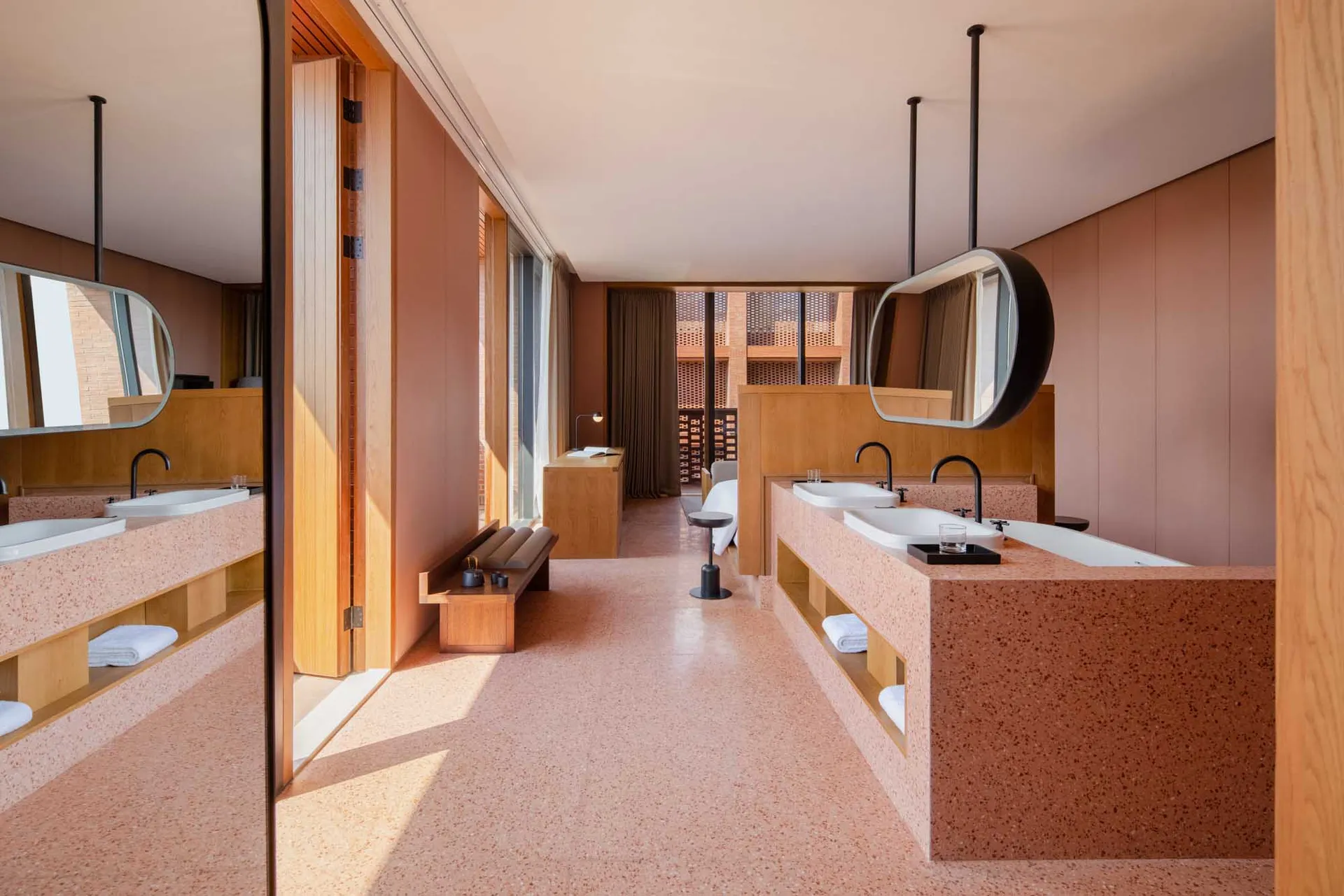 A modern hotel room featuring a terrazzo interior design with a minimalist and contemporary aesthetic.