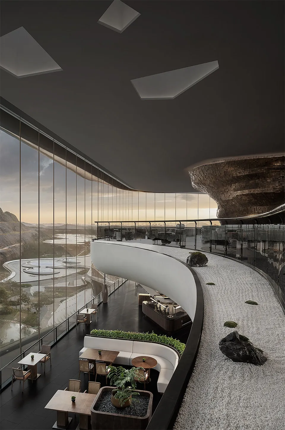 High-ceilinged restaurant featuring industrial design elements with metal, glass, and concrete materials.
