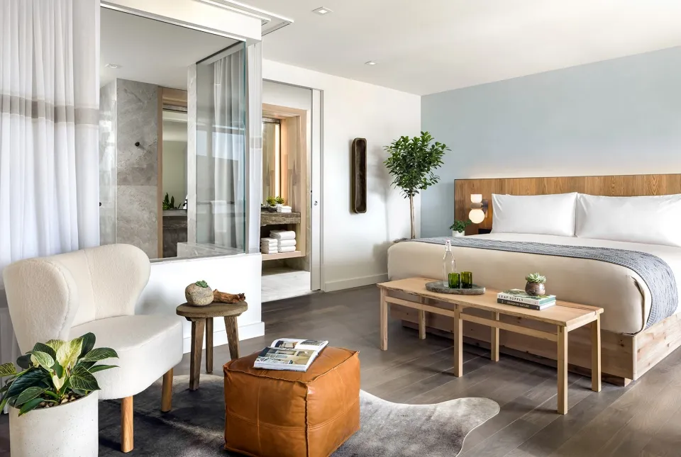 A modern residential bedroom featuring wood, leather, and glass materials.