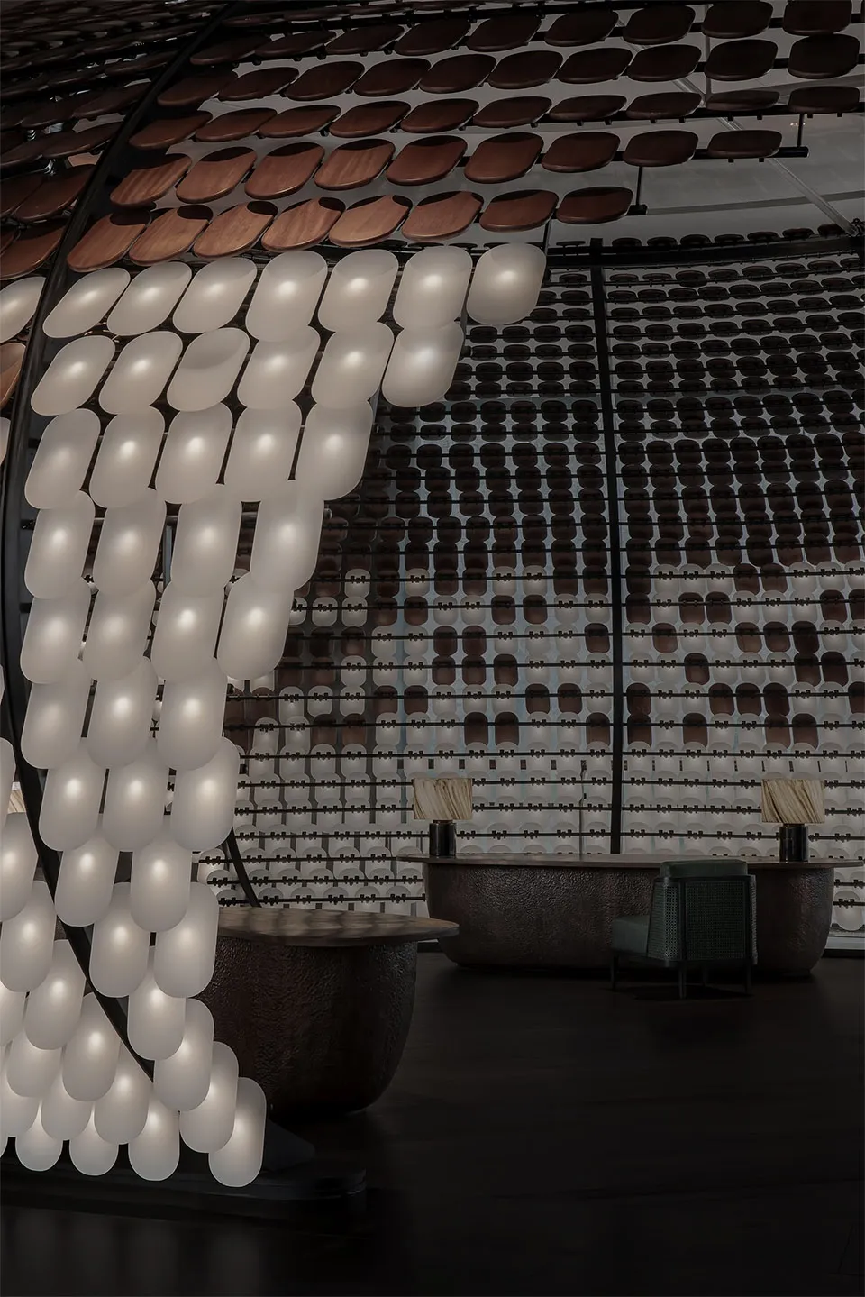 Modern restaurant interior with industrial lighting, concrete bar, and seating