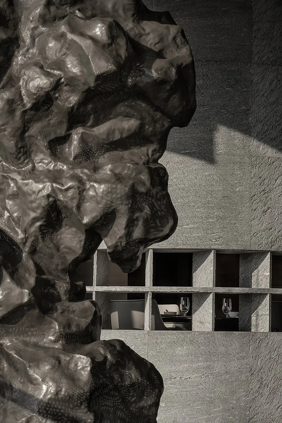 An interior photograph showcasing a modern restaurant with concrete shelving, emphasizing the minimalist design and industria