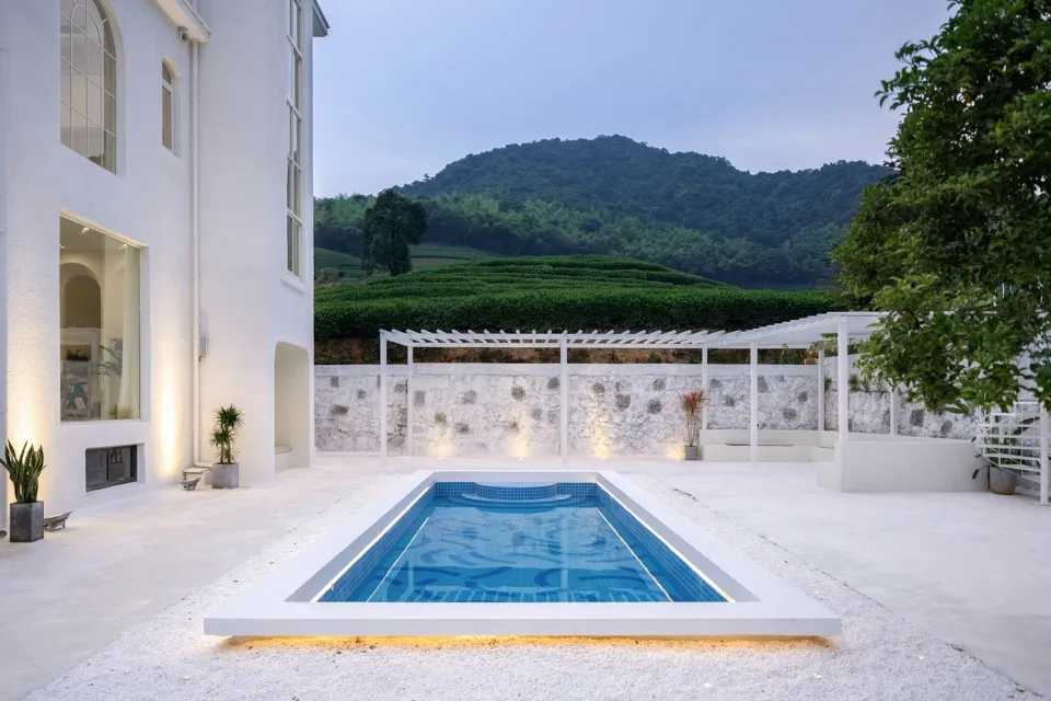 Modern pool house with concrete and glass materials
