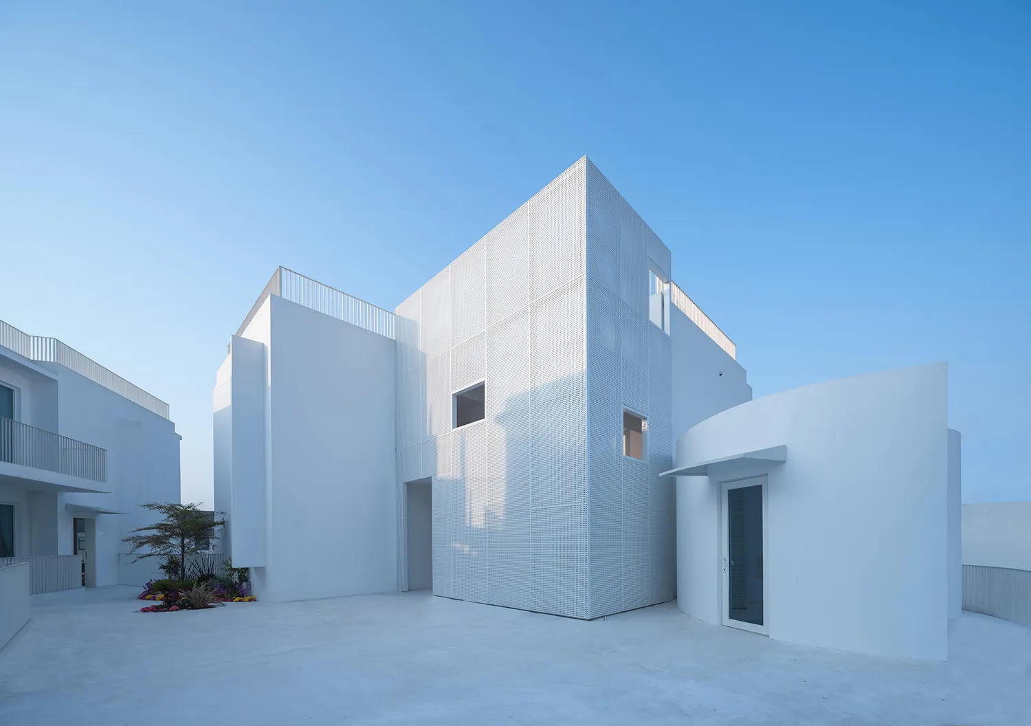 Modern building with white architecture and concrete elements.