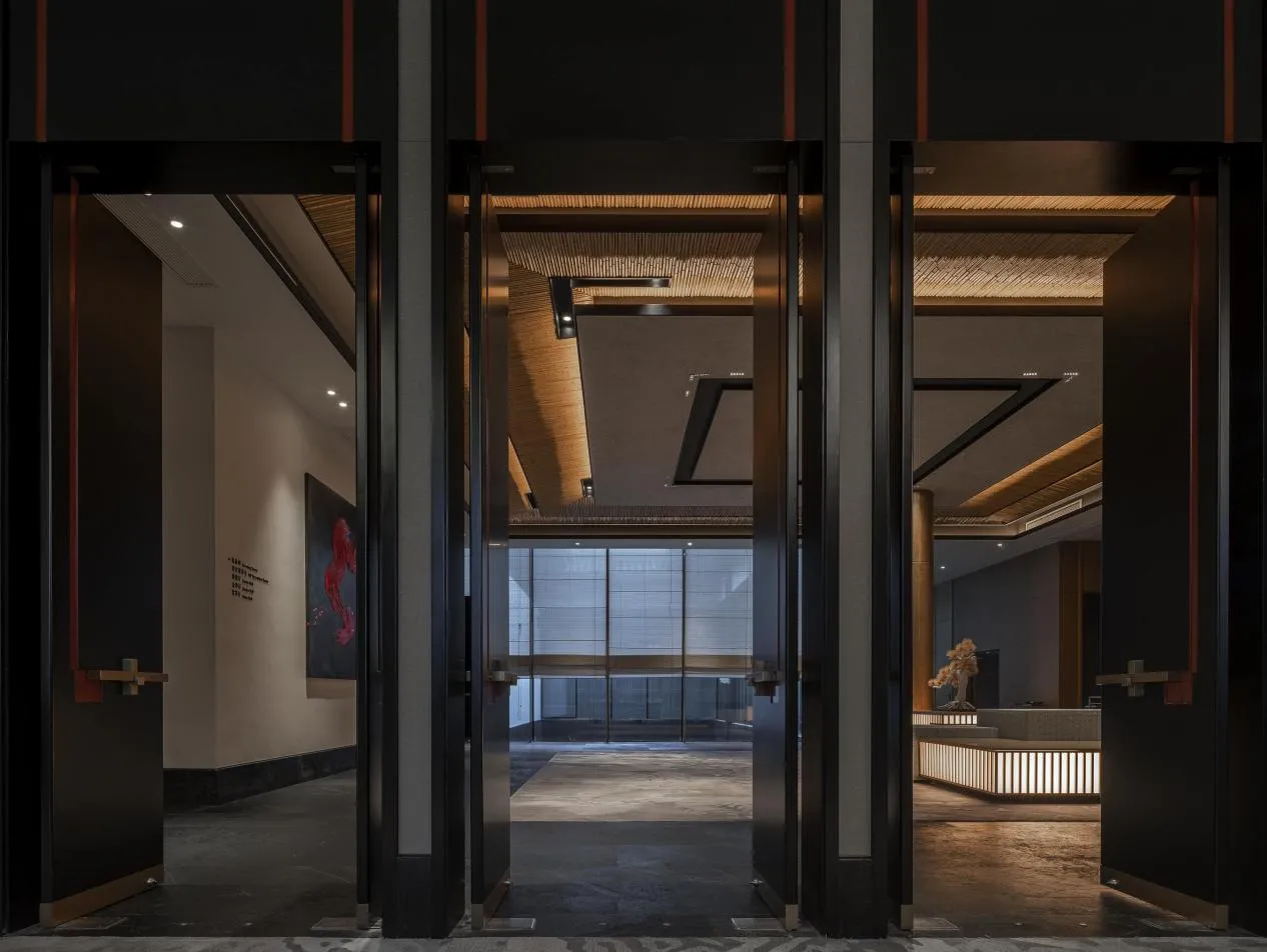A modern lobby featuring metal walls and wooden ceiling beams.