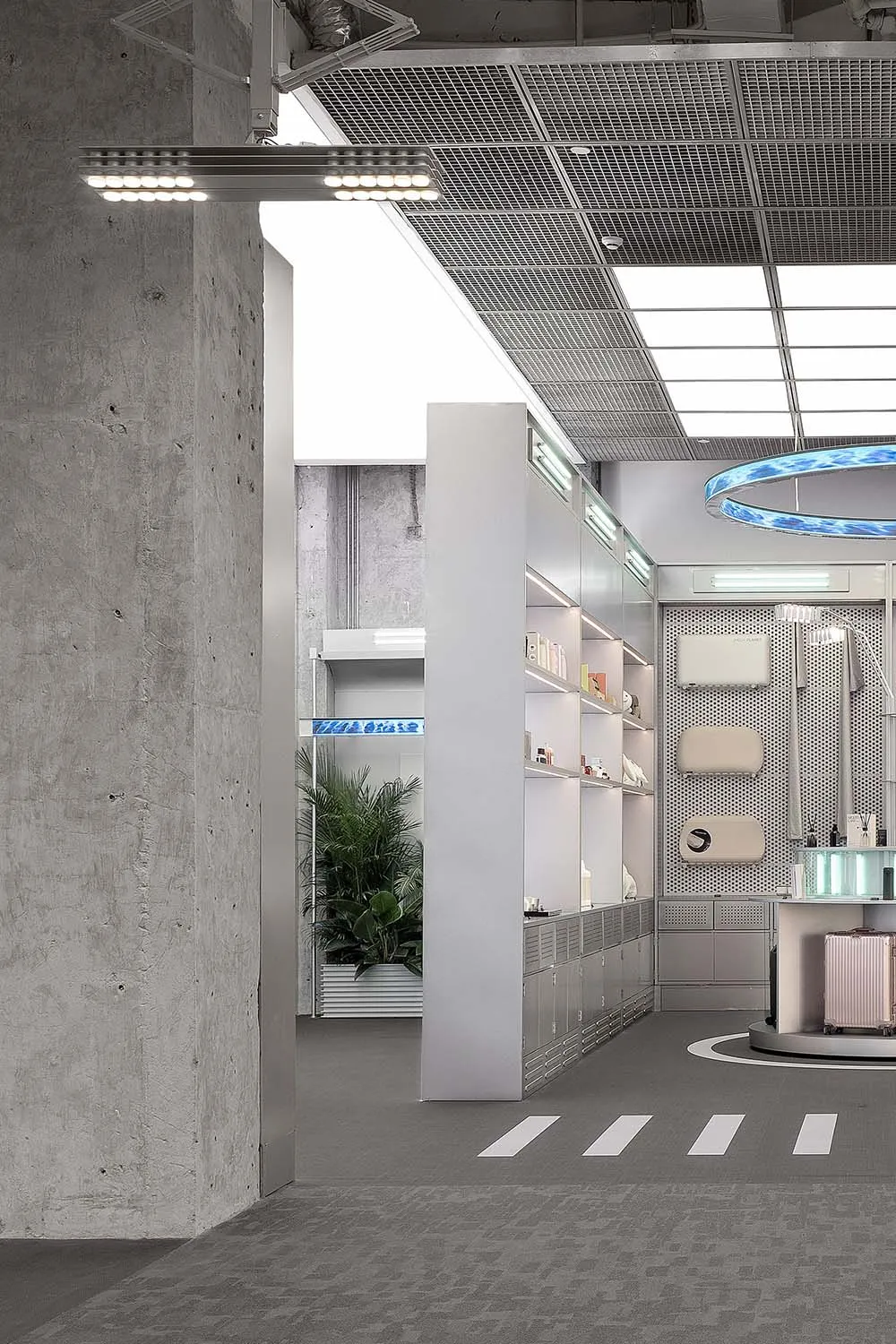 Modern minimalist storefront with concrete walls, metal accents, and large glass windows.