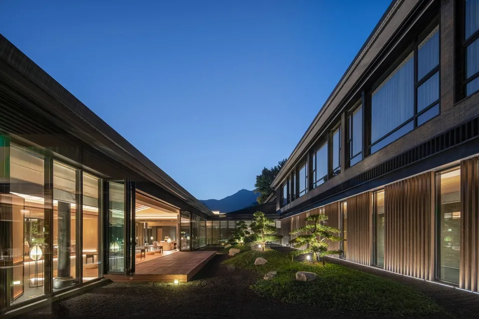 Modern exterior and interior design featuring wood and cement materials.