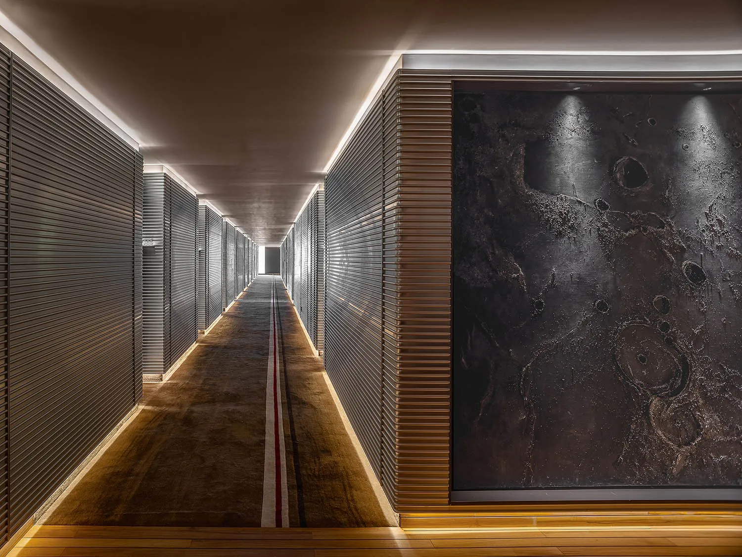 A modern metal corridor with a minimalist design, featuring a long hallway with dark metal walls, a light-colored floor, and