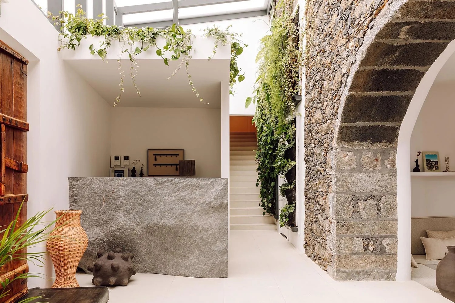 A modern living space featuring stone, concrete, and wood elements.