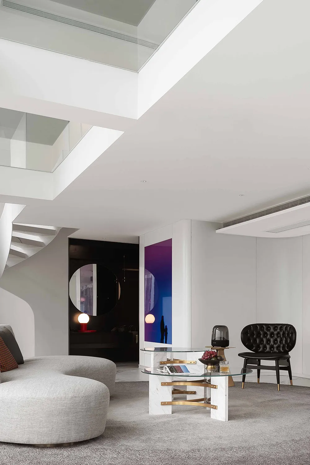 Modern loft interior with marble flooring, glass walls, and leather seating.