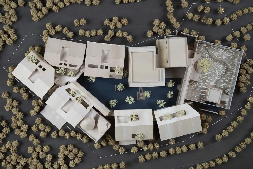 Aerial view of a modern residential architecture layout featuring wooden structures and greenery.