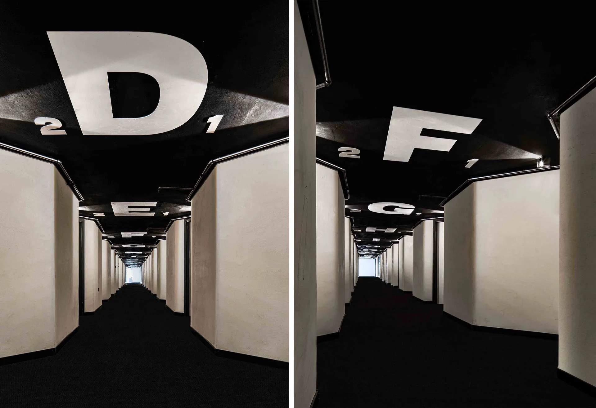 A modern industrial corridor interior design featuring a metal ceiling layout and large white letters on the ceiling.