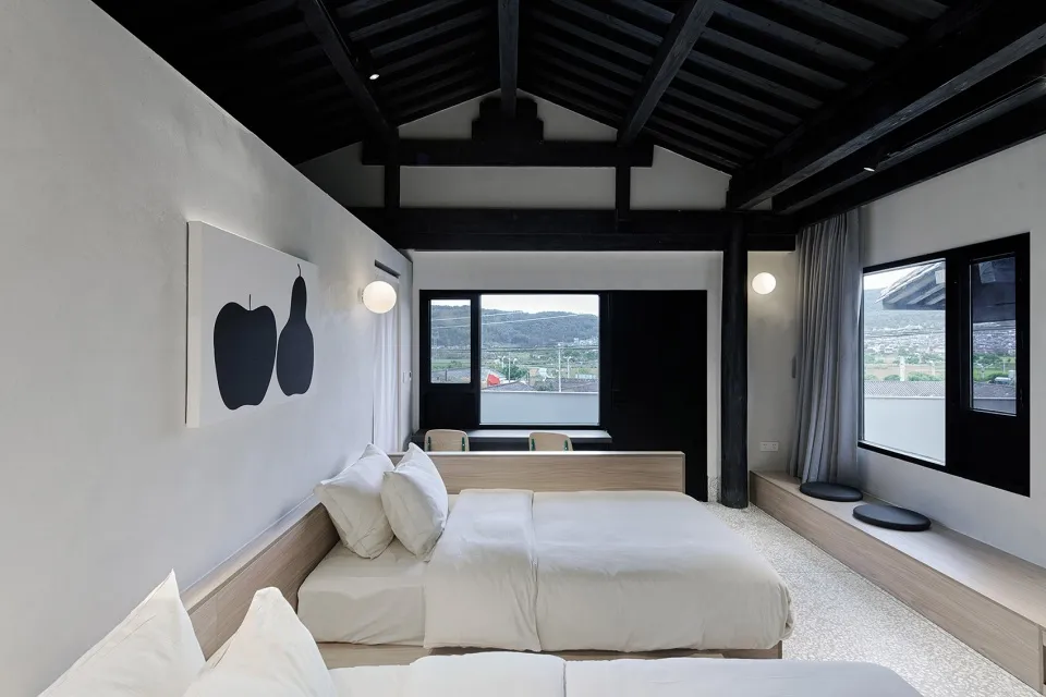 Modern bedroom with white furniture and minimalist decor.