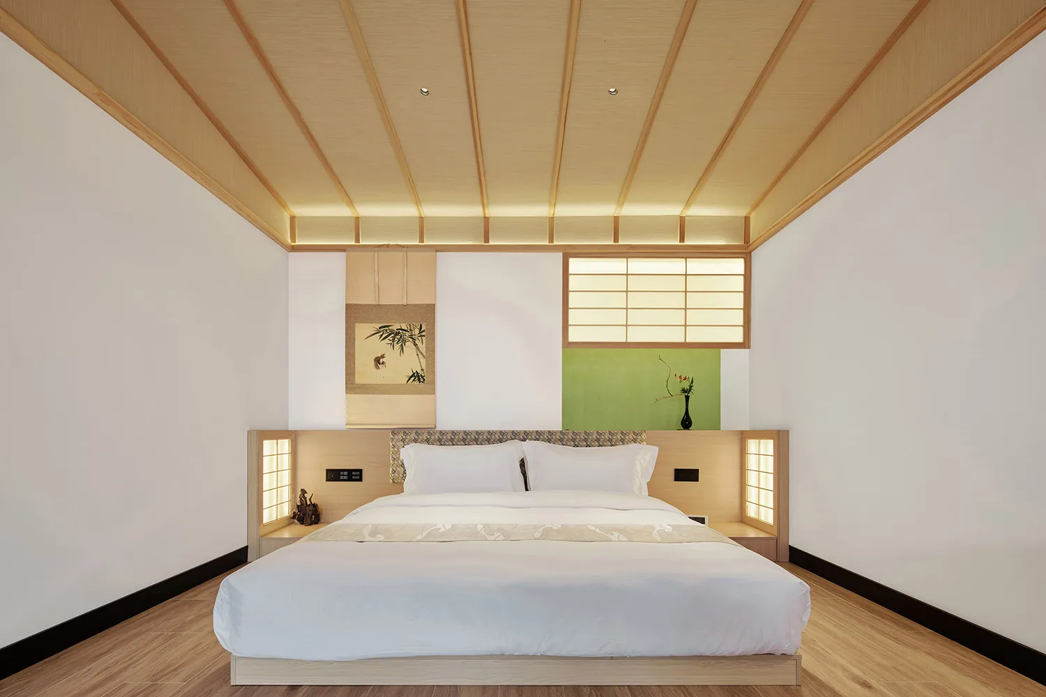 A modern bedroom with wooden elements, white bedding, and a minimalistic design.
