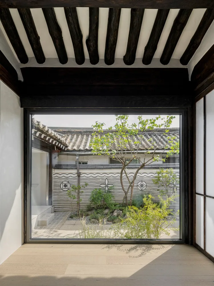 Modern house interior with glass walls and wooden floor and beams