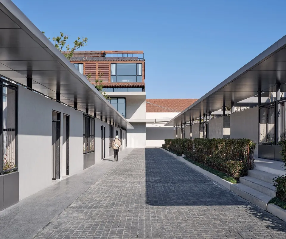 A modern exterior residential residence with concrete walls and metal railings.