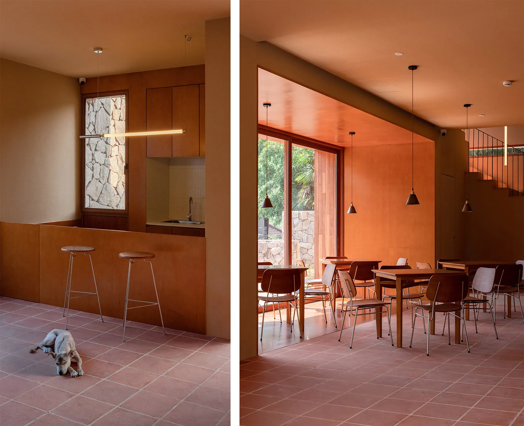 A modern residential interior with hanging lighting and wooden furniture.