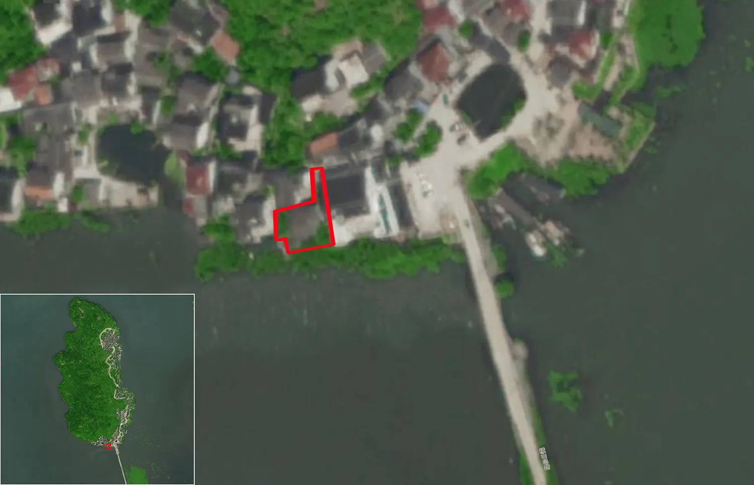 衛星俯瞰小村落,紅色輪廓標示建築物,橋樑橫跨河流。