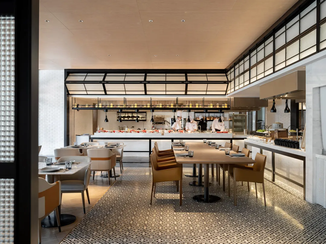 Modern restaurant interior with tile floor pattern and white walls.
