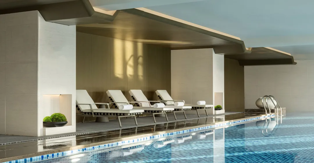 Minimalist-style swimming pool with concrete walls and tiled floor.