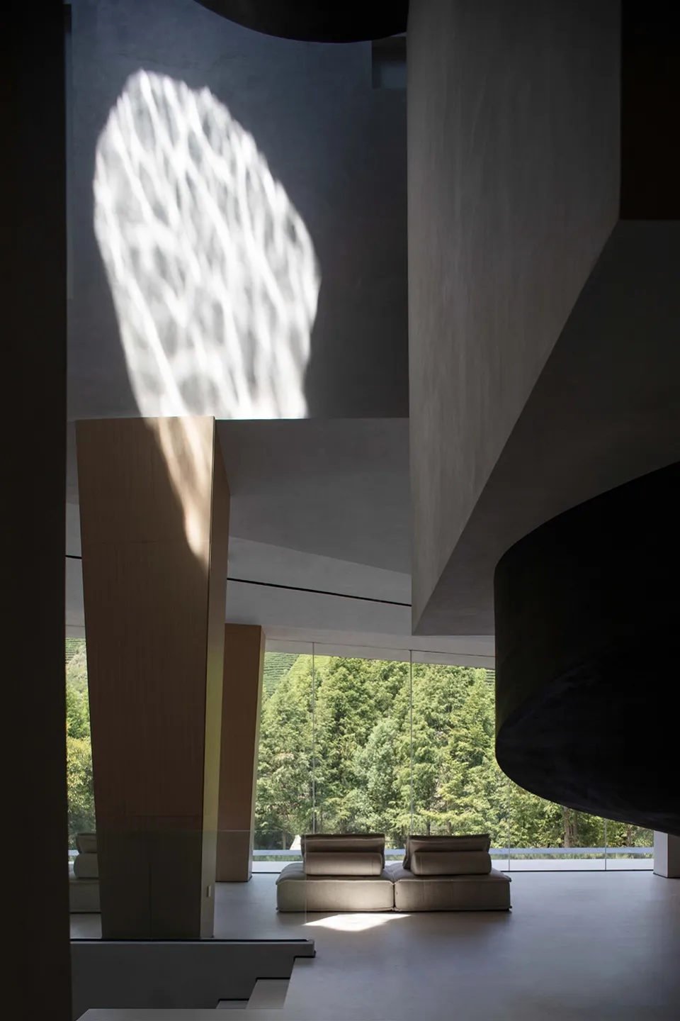Modern living room featuring glass and concrete materials