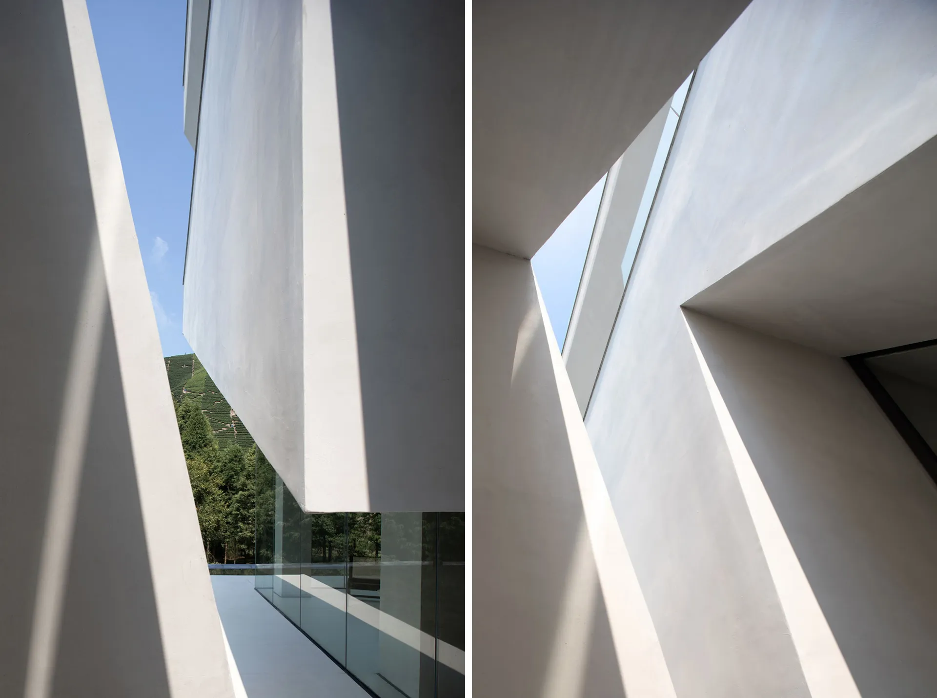 Modern minimalist interior with white concrete walls and ceiling, featuring geometric architectural elements.