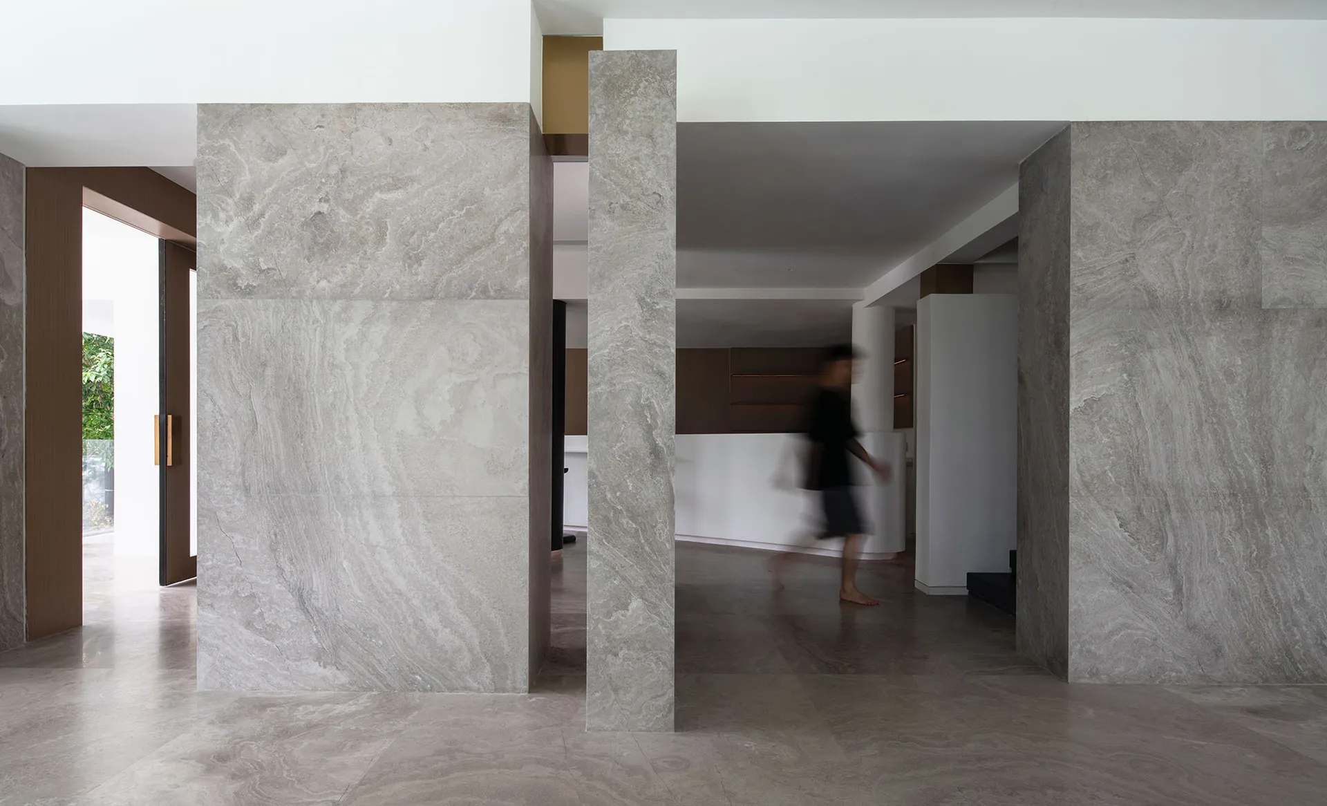 A modern living room with marble walls and floors.