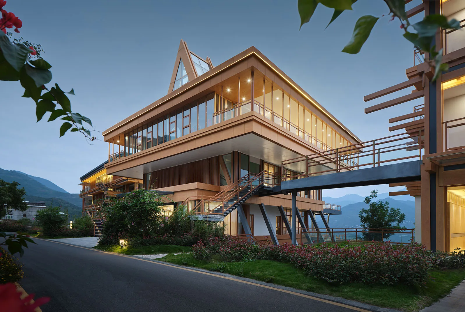 Modern residential building exterior featuring wood and glass materials.