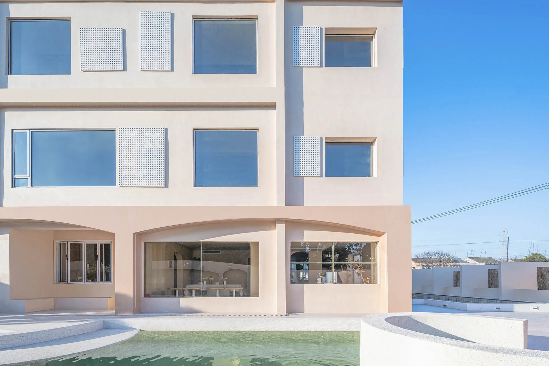 A modern building with concrete facade and large windows.