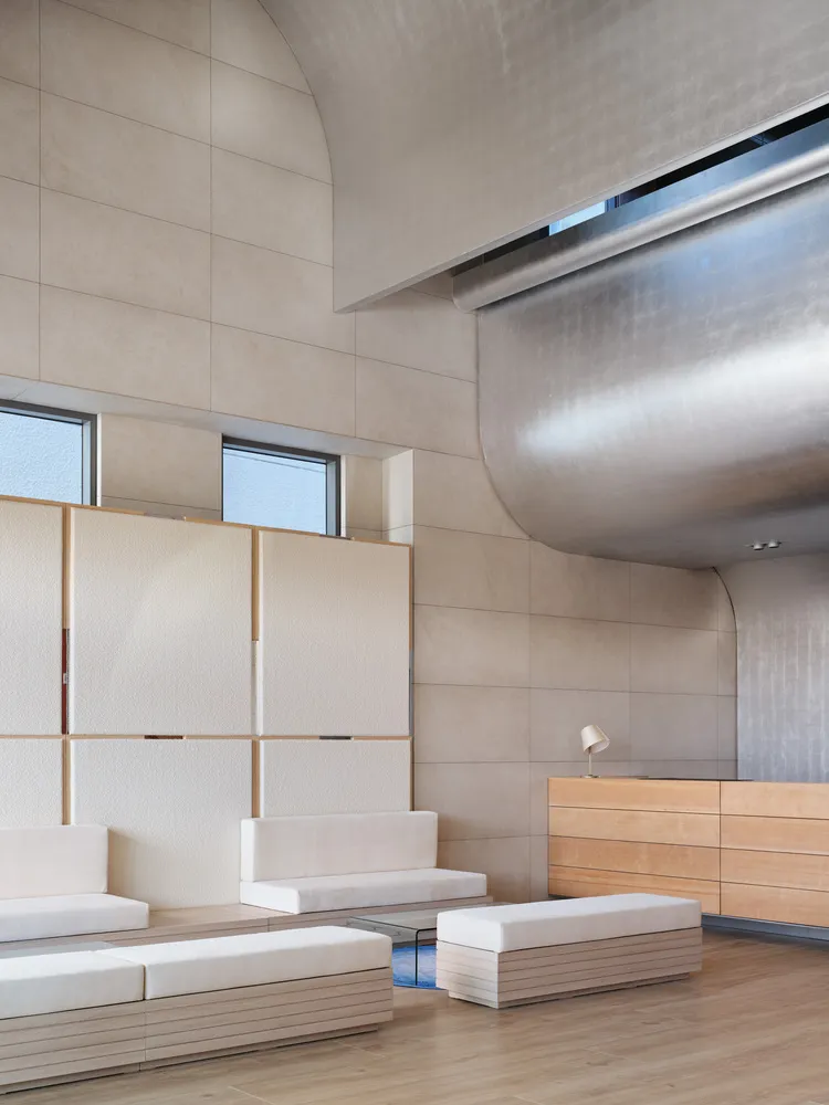 A modern office space with concrete walls and minimalist furniture
