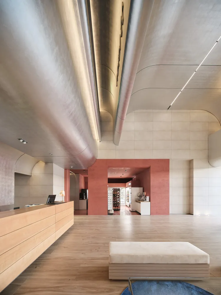 Modern lobby interior with metal, concrete, and wooden elements