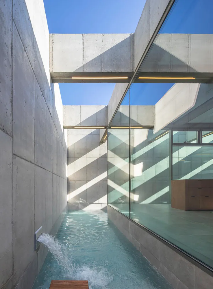 Modern interior design featuring concrete and glass materials