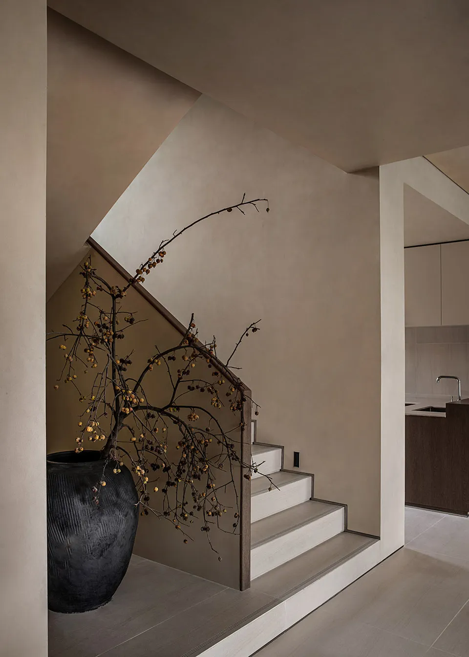 Minimalist stairs made of concrete, decorated with ceramic tiles in a modern setting
