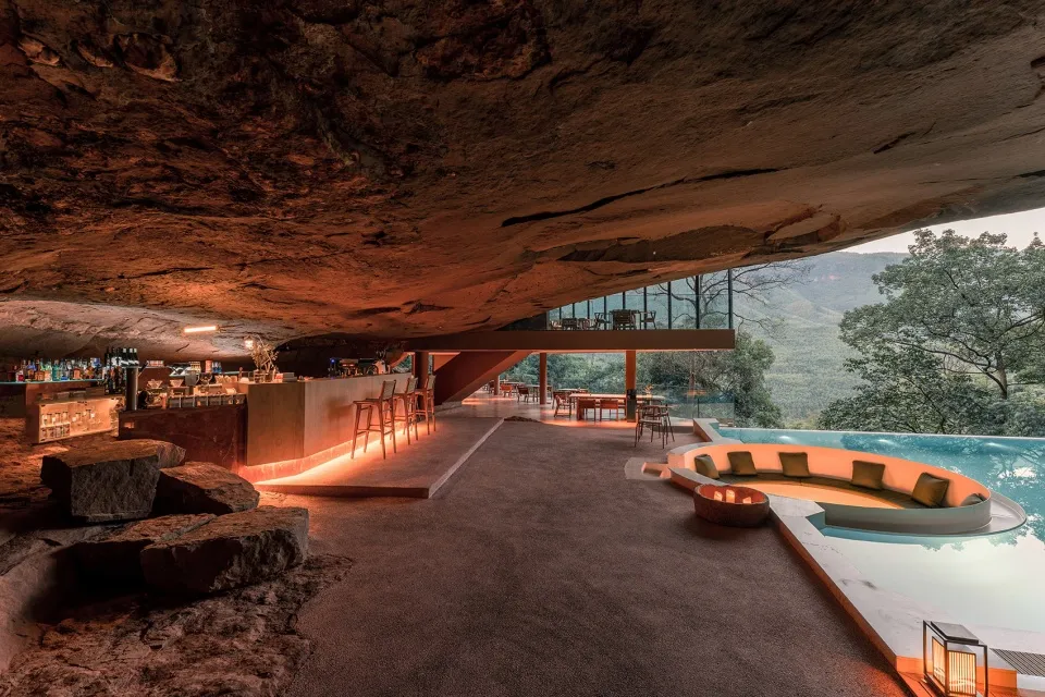 A modern residential space featuring concrete materials and a cave-like architecture
