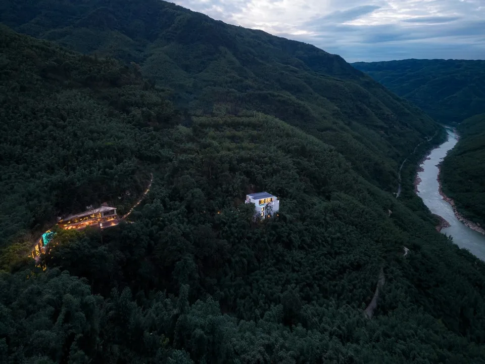 A modern residential lodge nestled in a forest on a mountain