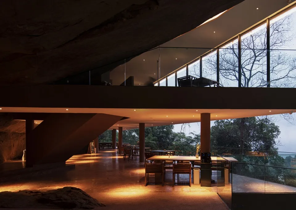 A modern restaurant interior with a concrete floor and open design.