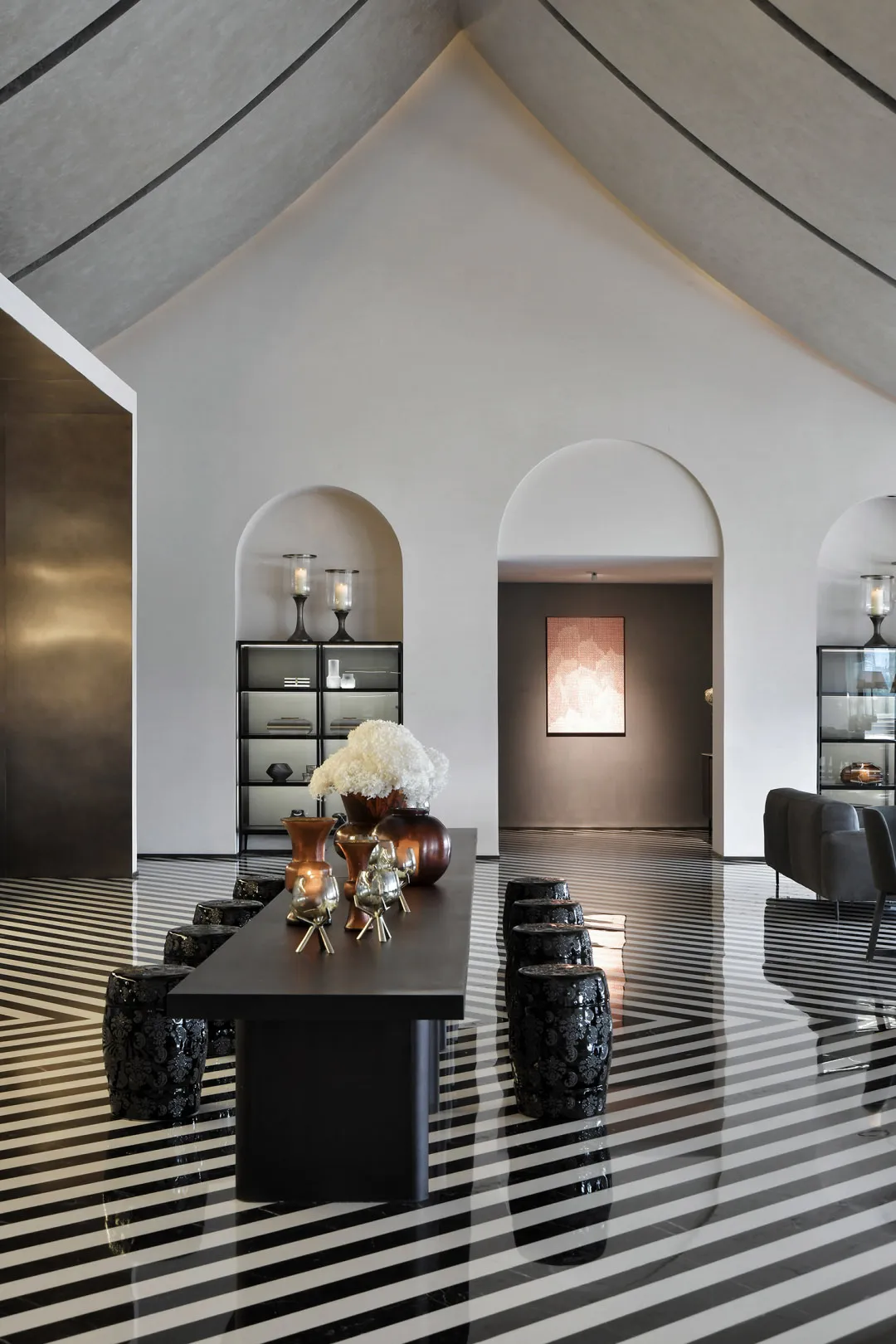 A modern living room with a striking concrete floor and minimalist design elements.