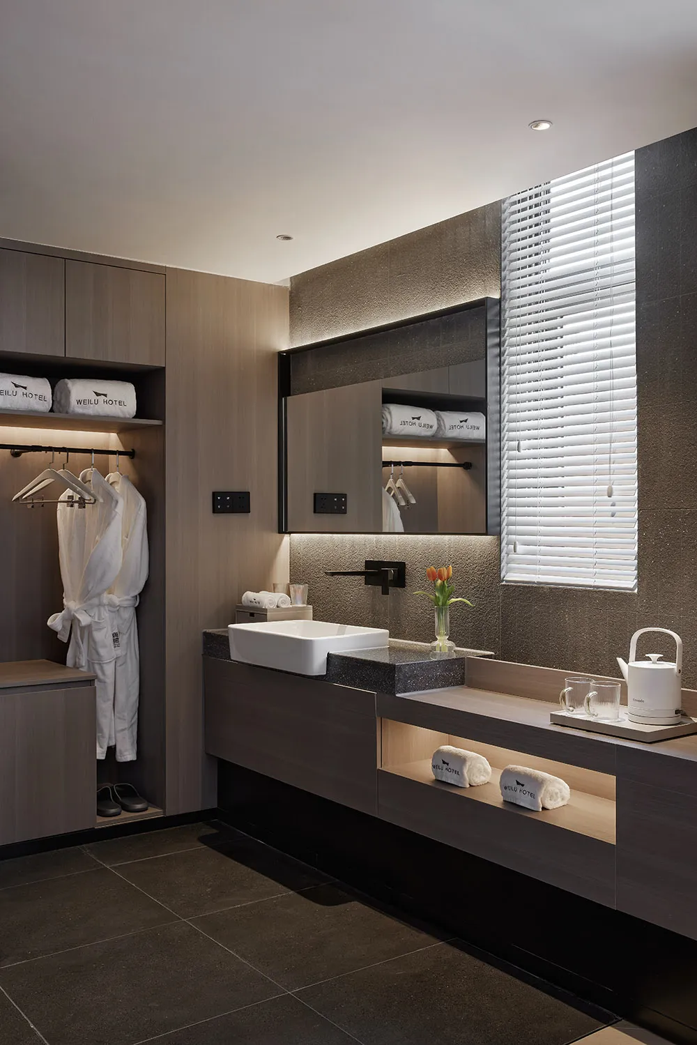 A modern residential bathroom featuring granite countertops and a clean, minimalist design.