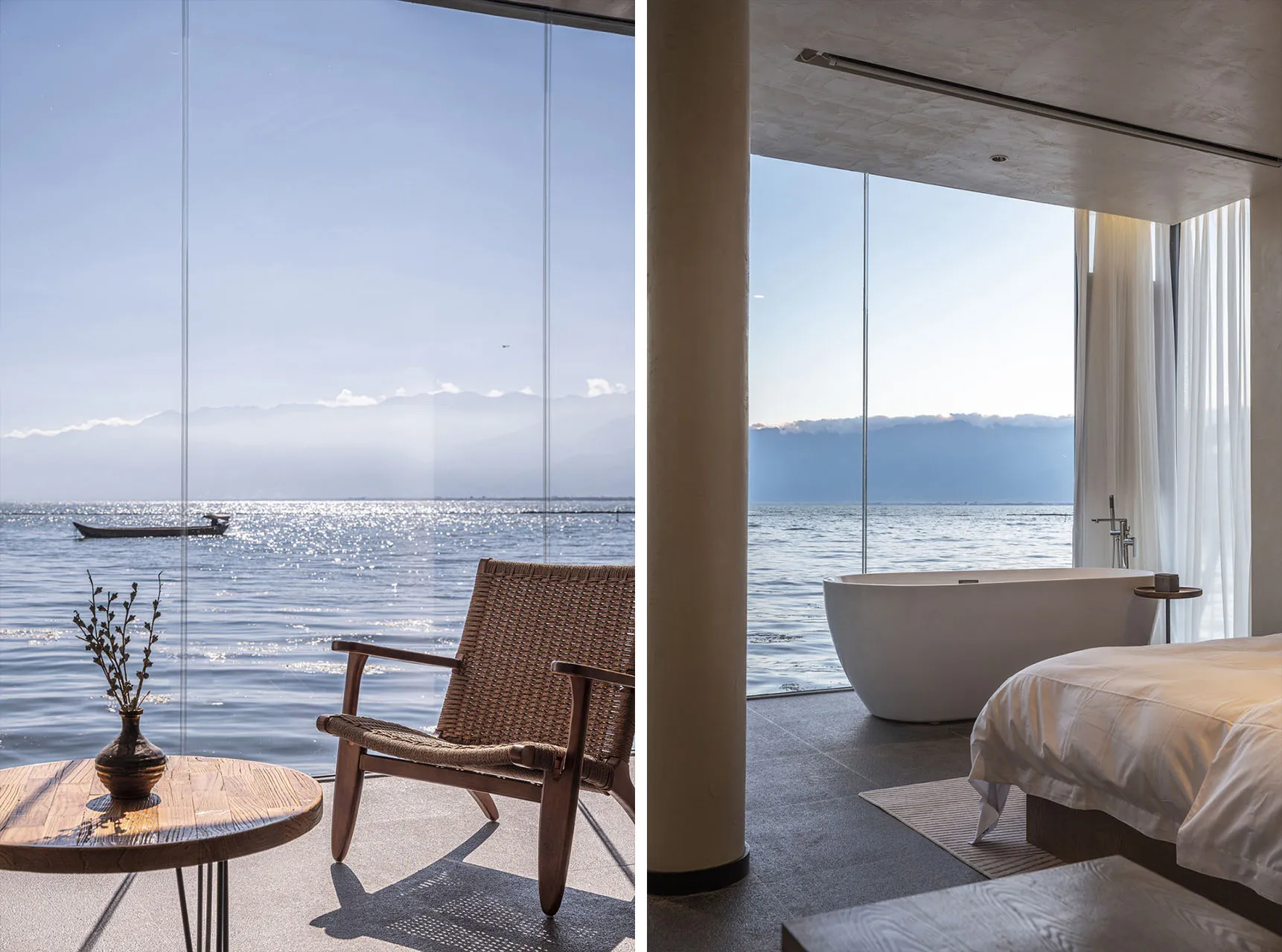 A minimalist residential interior with a concrete floor, a freestanding bathtub overlooking the water, a bed with white linen