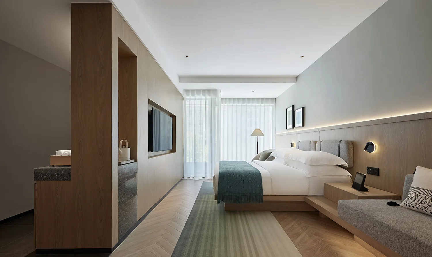 A modern bedroom featuring a wooden floor and minimalist design elements.