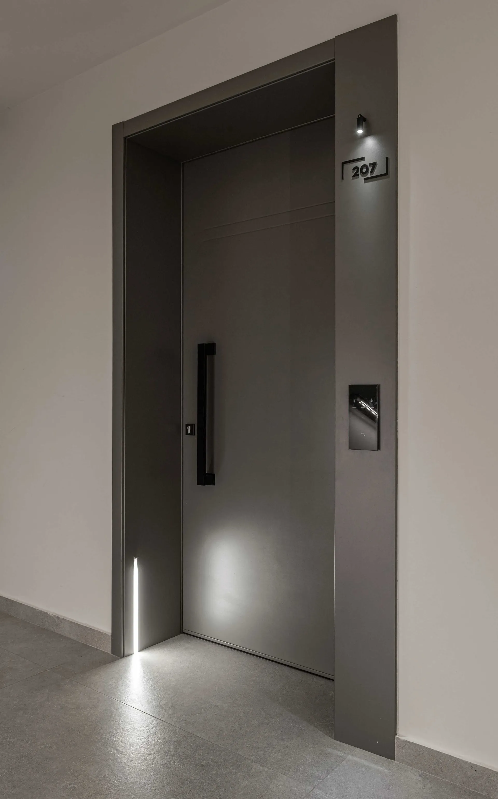 Modern interior with a metal door entrance, featuring sleek design and minimalist aesthetics.
