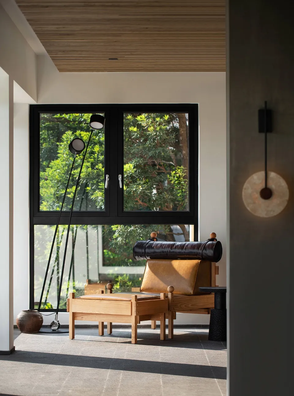 Contemporary living room with wooden furniture, leather accents, and glass elements.