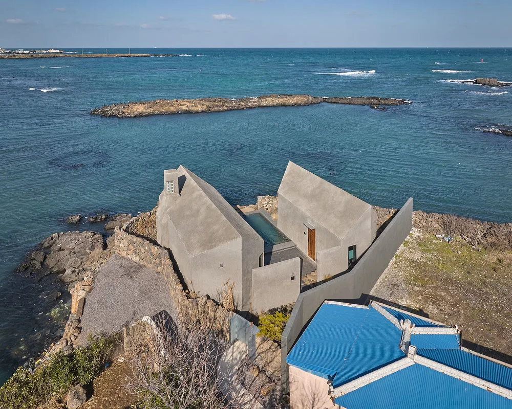 Modern vacation home designed in concrete, with a pool overlooking the ocean.