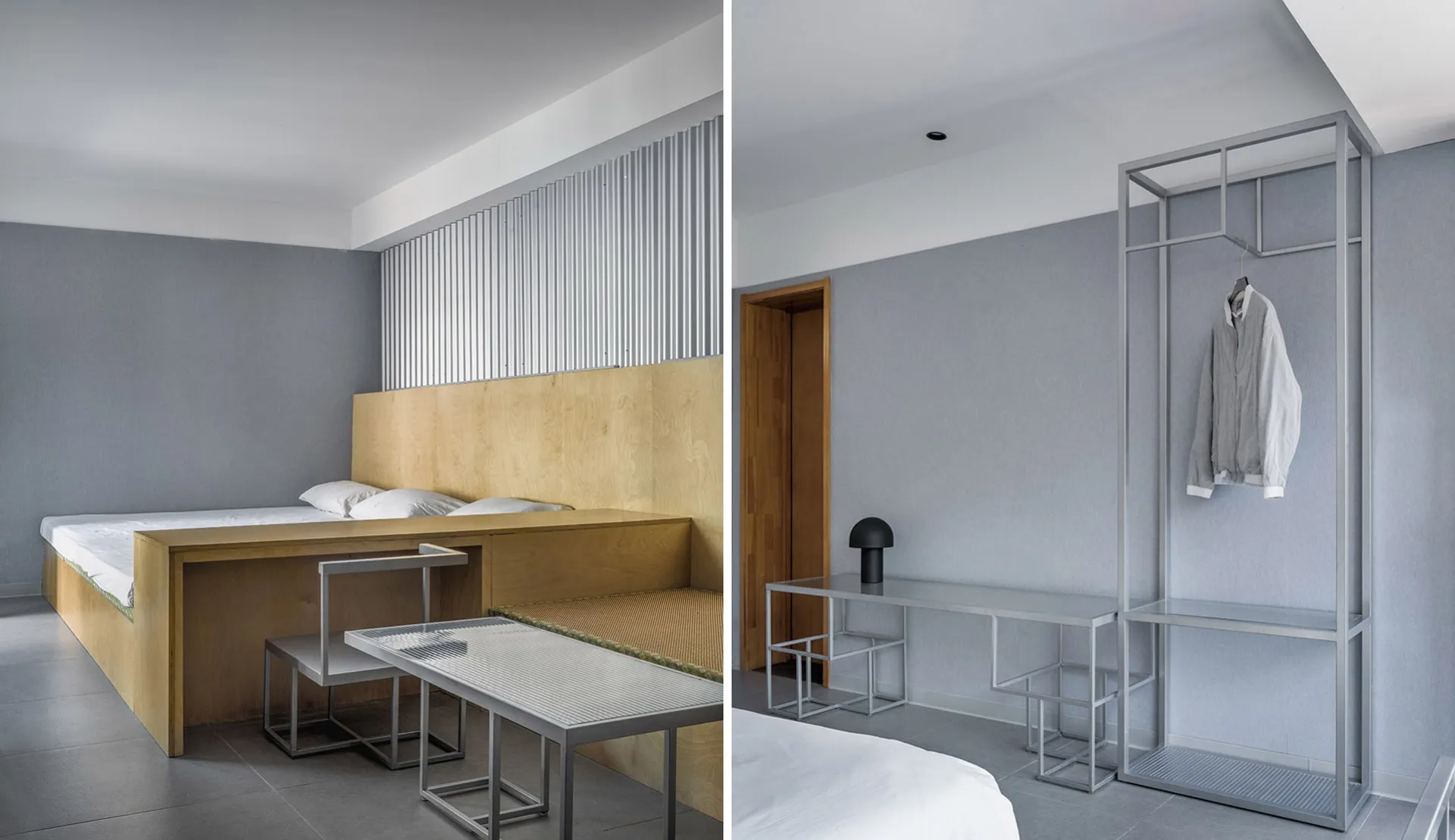 A minimalist bedroom with a metal structure, featuring a bed, desk, and integrated cabinets.