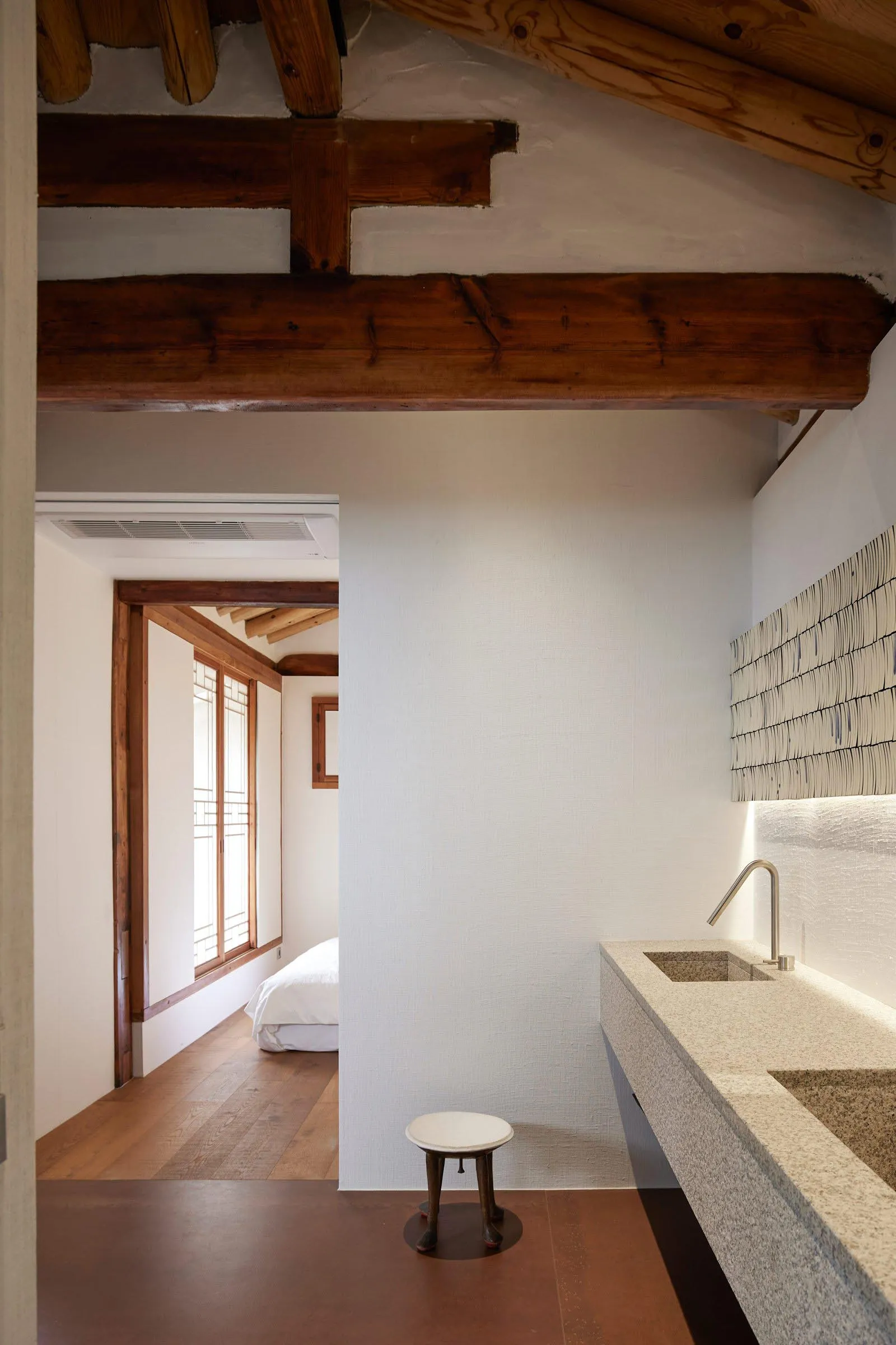 A minimalist residential kitchen with concrete and stone materials.