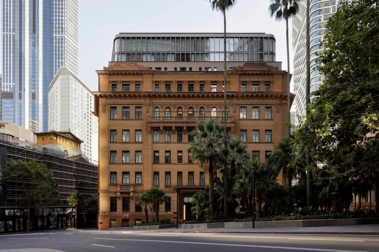 A classical office building with a concrete exterior stands prominently in the cityscape.