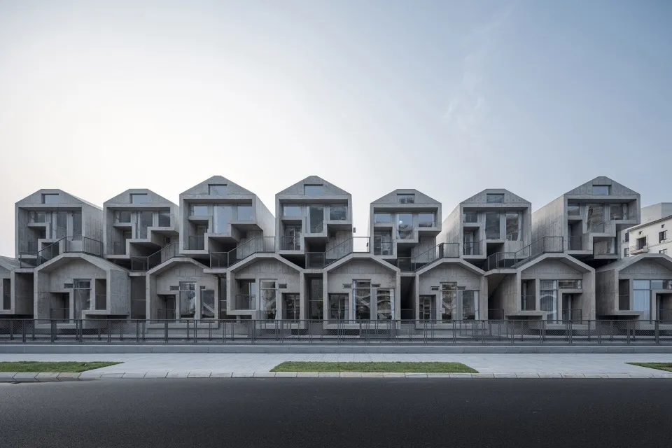Multiple-storied, modern, concrete residential buildings with large windows.
