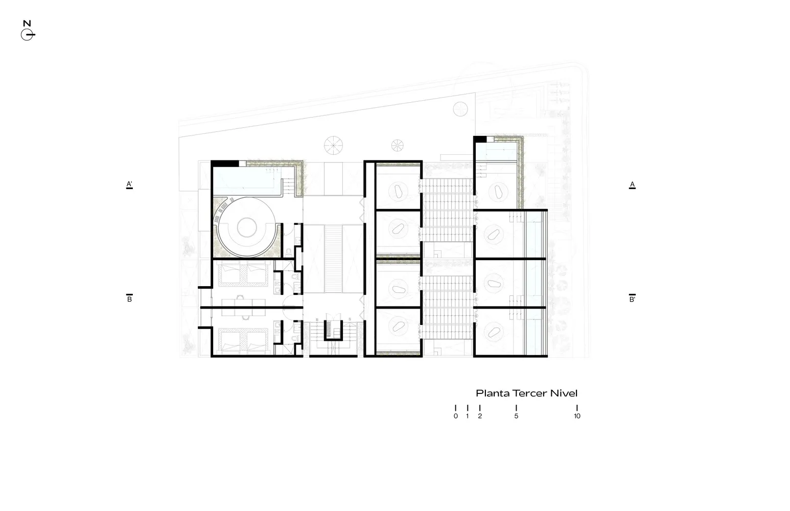 A modern architectural floor plan of a building featuring a ground-level plan with concrete flooring and multiple functional 
